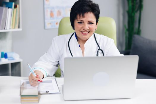 Female doctor making online video call consulting patient. European woman therapist talking to camera in remote chat. Telemedicine, telehealth. Modern medecine concept