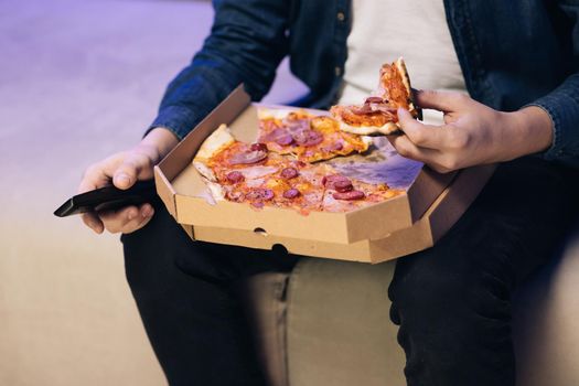 Food delivery service at party catering concept. Opening a pizza box. Unrecognizable hand opening delivery box with hot delicious pizza inside.