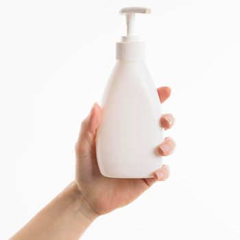 hand holding liquid soap bottle. High resolution photo