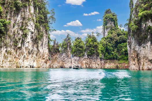 Wooden Thai traditional long-tail boat on a lake with mountains at Ratchaprapha Dam or Khao Sok National Park, Surat Thani Province, Thailand