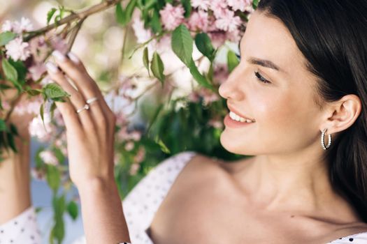 Portrait of a Gorgeous Dark Haired Hispanic Woman Charmingly while Standing in the Middle of Modern Urban City Landscape, Wearing White Dress. Young Woman Enjoys Life.