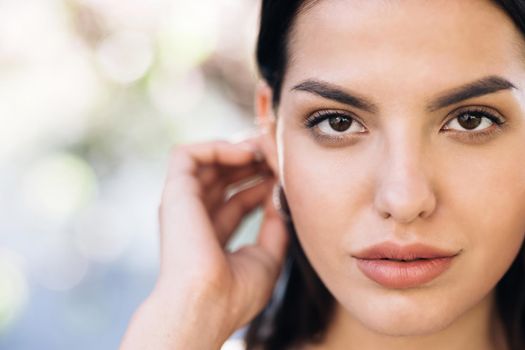 Close up of Womans Face, Girl with her Beautiful Brown Eyes. Natural Beauty Face Woman. Gorgeous Woman with Attractive Appearance. Gorgeous Dark Haired Hispanic Woman