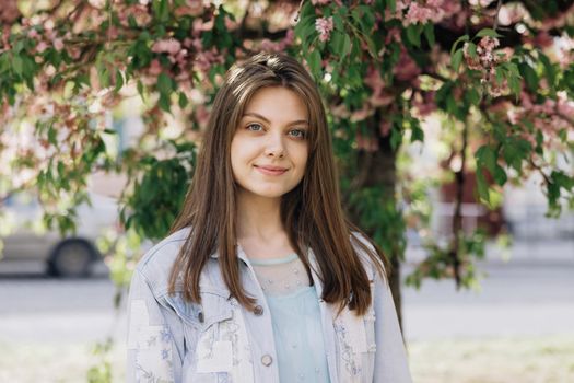 Smiling young woman in outfit looking to camera outside on street feel happy girl portrait beautiful modern woman pretty