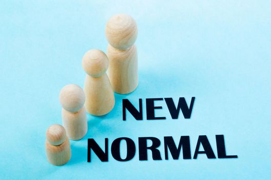 Person wooden doll standing with New normal. Life after pandemic concept.