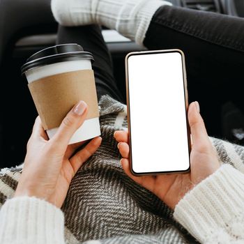 front view woman holding blank phone cup coffee. High resolution photo