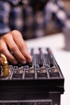 Close up of vlogger checking sound while speaking during interview. Creative online show On-air production internet broadcast host streaming live content, recording digital social media communication