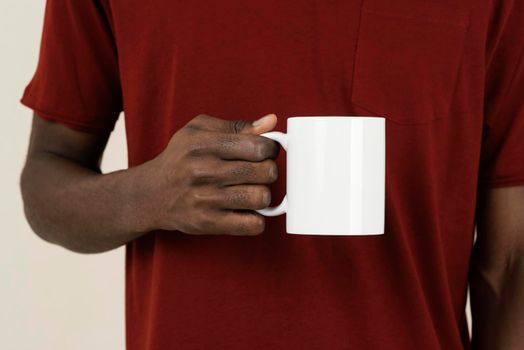 front view man t shirt holding mug. High resolution photo