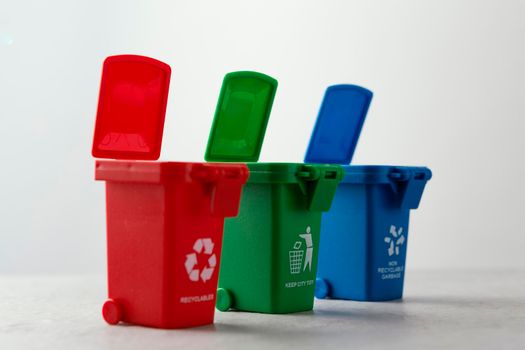 three miniature recycle bins. High resolution photo