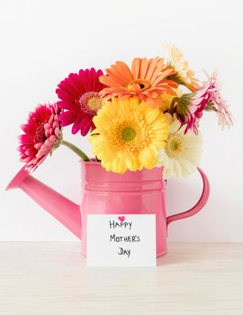 arrangement with flowers watering can. High resolution photo