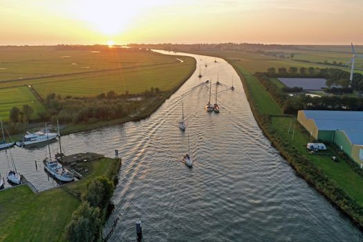 Aerial from sailing boats at sunset in Friesland the Netherlands