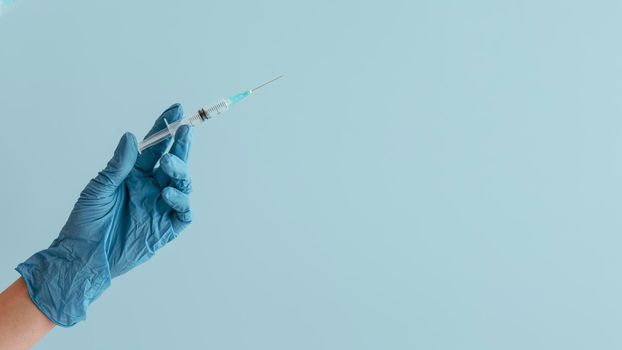 hand glove holding syringe. High resolution photo