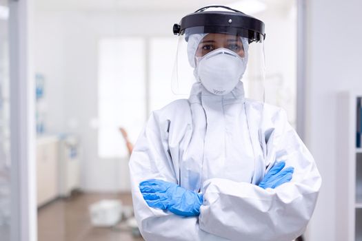 Physician wearing face shield and hazmat suit agasint contamination with coroanvirus. Medical personal dressed in protection equipment against infection with covid-19 during global pandemic.
