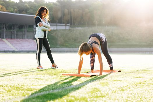 Young girl doing exercises under physiotherapist supervision. Patient Uses Physical Therapy to Recover from Surgery and Increase Mobility. The Doctor Works on Specific Muscle Groups or Joints.