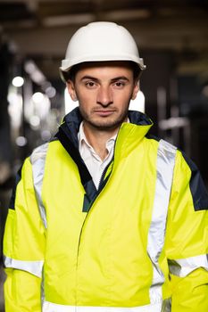 Caucasian business people in hard hat or safety wear. Professional male industry engineer specialist. Portrait of a frontline essential worker in a warehouse.