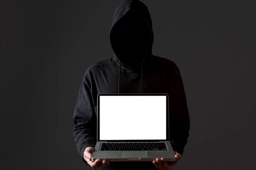 front view male hacker holding laptop. High resolution photo