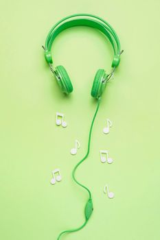 green headphones with white musical notes. High resolution photo