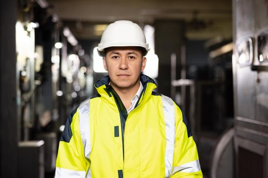 Portrait of confident, handsome male Foreman in hardhat looking to camera in logistic, export, import industry. Transportation concept.