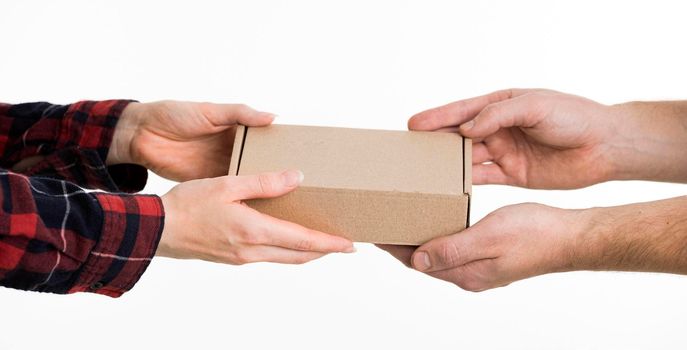 hands exchanging cardboard box. High resolution photo