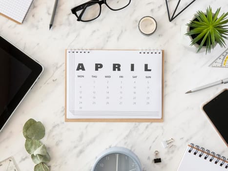top view desk april calendar. High resolution photo