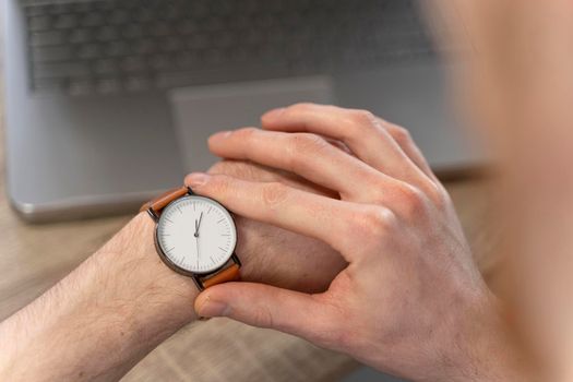 high angle man looking his watch. High resolution photo