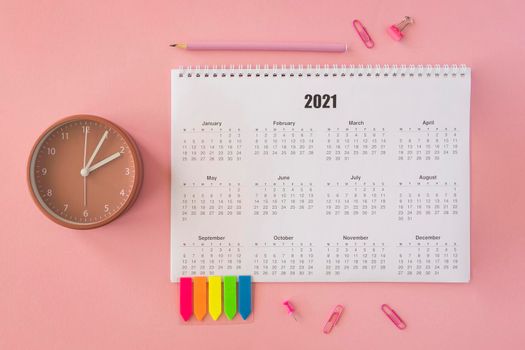 flat lay desk calendar pink background. High resolution photo