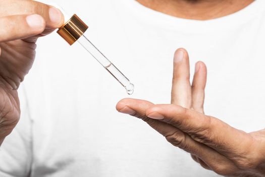 hands holding serum pipette. High resolution photo