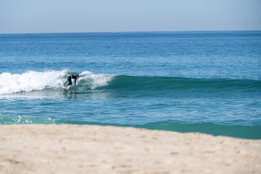 Soul surfer girl riding a wave in Furadouro beach, Ovar - Portugal.