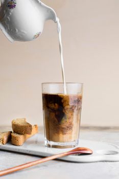 front view milk being poured frappe slices bread with seeds. High resolution photo