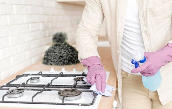 man disinfecting stove. High resolution photo