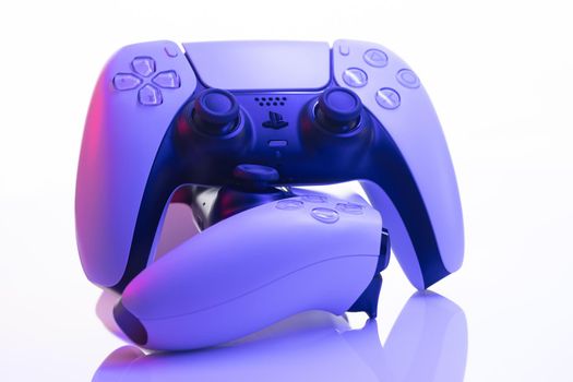 Lviv, Ukraine - February 27 2021: Two joysticks from Sony PlayStation 5 TV game console on a white background. Close up view of 2 controllers from new console
