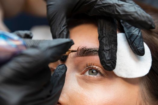 young woman getting beauty treatment her eyebrows. High resolution photo