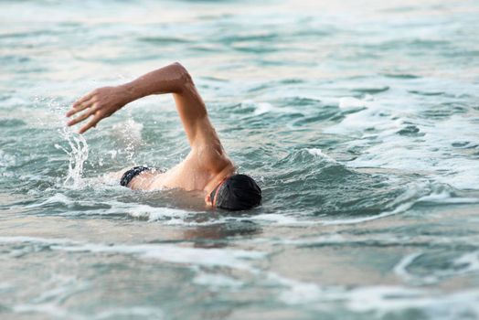 male swimmer swimming ocean. High resolution photo