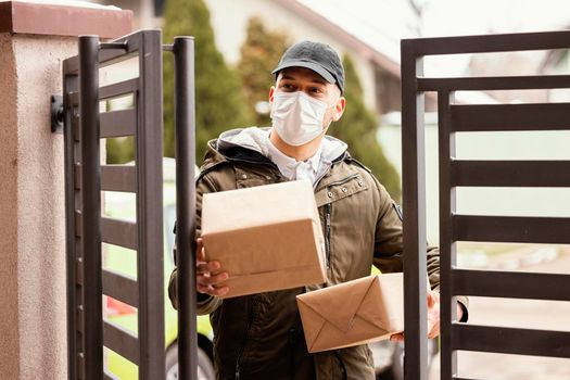 delivery man package wearing mask. High resolution photo