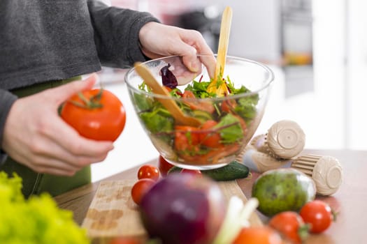 hand holding bowl salad. High resolution photo