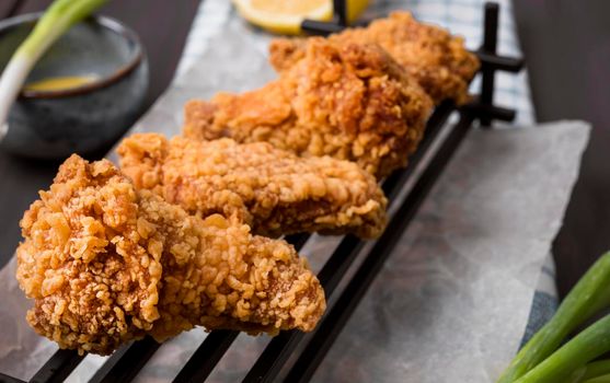 fried chicken wings tray green onions. High resolution photo