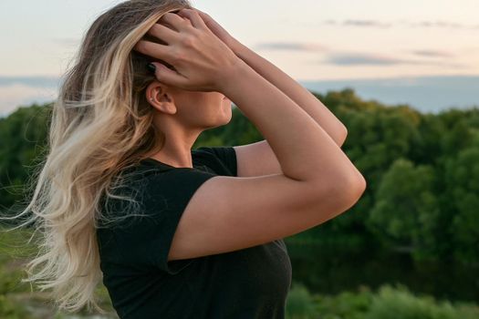 portrait of a beautiful European girl with loose hair against the background of nature. selective focus