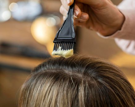 woman getting her hair dyed home by hairdresser. High resolution photo