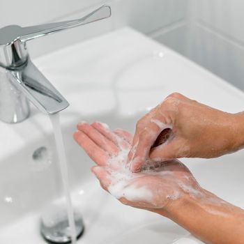 person washing hands with soap . High resolution photo