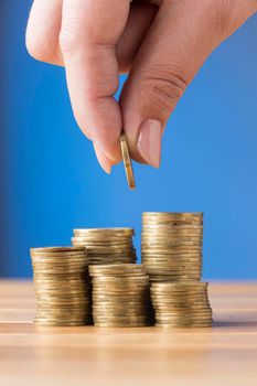 person placing coin pile coins. High resolution photo