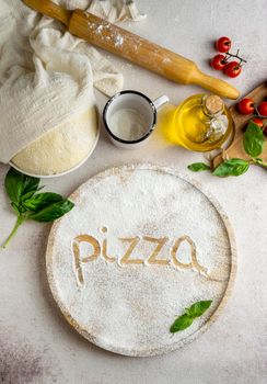 top view pizza dough with tomatoes word written flour. High resolution photo