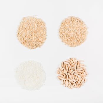 uncooked white brown puffed rice isolated white backdrop. High resolution photo