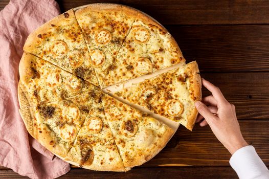 top view hand taking slice pizza cheese. High resolution photo