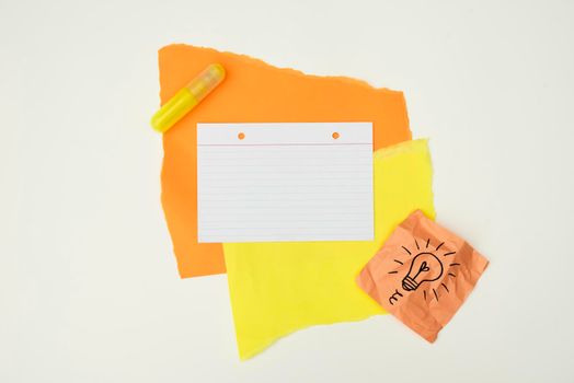 color paper glue with hand drawn light bulb note paper isolated white background. High resolution photo