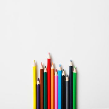 row sharp colored pencils against white background. High resolution photo