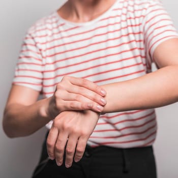 mid section young woman having pain wrist. High resolution photo