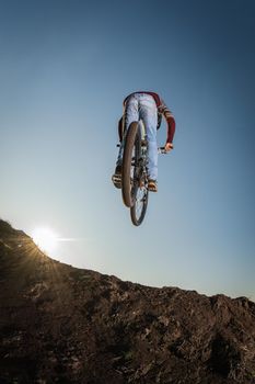 MTB Bike jump over a dirt trail on a dirt track.