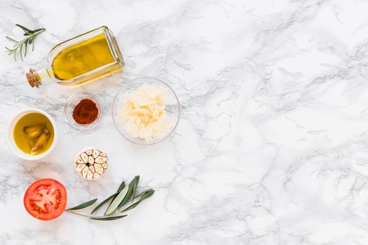 various ingredients with oil white marble background. High resolution photo
