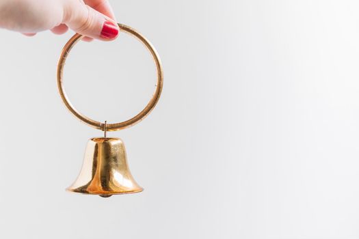 woman holding small bell hand. High resolution photo