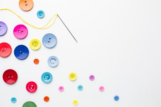 clothes colourful buttons with needle . High resolution photo