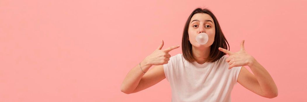 girl pointing bubble gum. High resolution photo